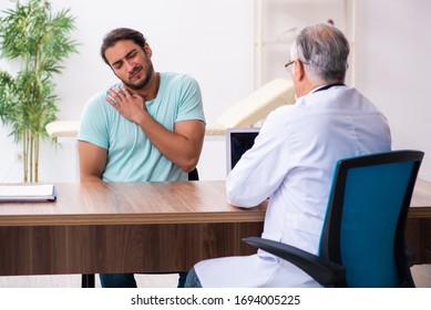 Injured Young Man Visiting Old Doctor