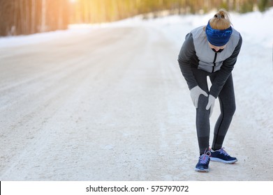 Injuries - Sports Running Knee Injury On Woman. Winter Marathon