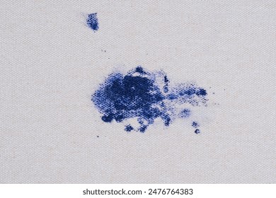 Ink splatter. Abstract splash of blue splatter on the upholstery of a couch or sofa. daily life stain concept. top view. High quality photo - Powered by Shutterstock