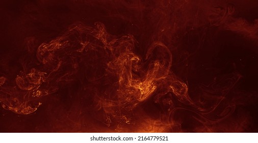 Ink water blend. Hellfire effect. Red orange fiery fluid mixing motion on black mist texture abstract background shot on Red Cinema camera 6k.