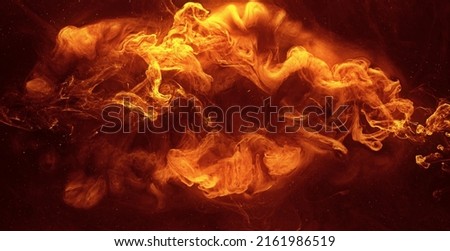 Ink water blend. Hellfire effect. Red orange fiery fluid mixing motion on black mist texture abstract background shot on Red Cinema camera 6k.