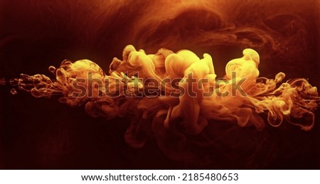 Ink water shot. Color vapor cloud. Hot burst. Orange red yellow glowing paint flow on dark burning steam texture abstract art background.