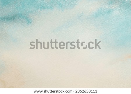 Ink and watercolor smoke flow stain blot on paper grain texture background. Beige blue pastel color.
