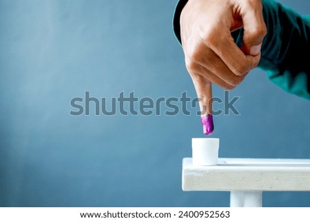 Inked pinky finger. Purple ink blots from voter's finger provides evidence of the presidential election in Indonesia.