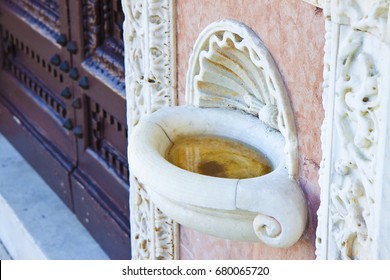 Inlaid marble holy water font in an Italian church