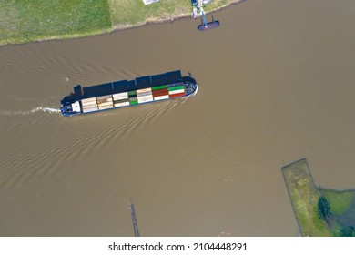 Inland container vessel on River Lek aerial view near the village of Ravenswaaij, Gelderland, Netherlands