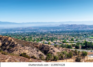 Inland Empire Of Southern California On Hot Summer Morning With Clouds And Houses Stretching Across The Valley