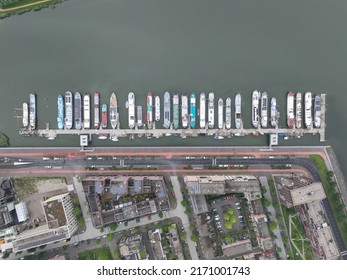 Inland vessel houseboat residential function living on a ark or ship housing pier dock village. Overhead aerial drone overview. Historical non movable ships barge vessels in Amsterdam.