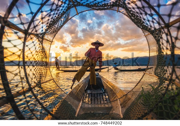 Inle\
Lake Intha fishermen at sunset in Myanmar\
(Burma).