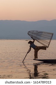 INLE LAKE, MYANMAR - MAR 7: Boatmen are fishing in Inle Lake during sunset on March 7, 2015 in Inle Lake, Myanmar.