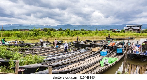 INLE,MYANMAR -AUG 16, 2015: Transportation and material transport of Intha monority people by longboat for quick access to the changes  in Inle lake,Shan State,Myanmar.