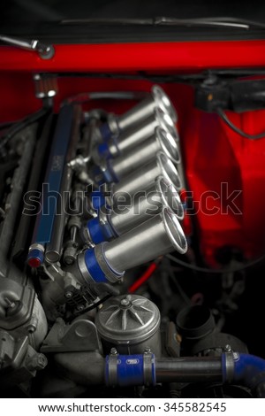 Inline six tuned racing engine. Shiny performance parts on a tuned racing car engine