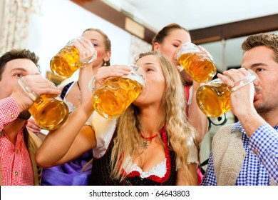 Inn Or Pub In Bavaria - Group Of Five Young Men And Women In Traditional Tracht Drinking Beer And Having A Party With Beer