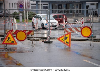 Inner City Road Closed By Signs And Boundary Around Street Works. Construction And Road Work Sign In Downtown. Caution Symbol, Work In Progress. 