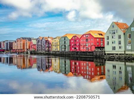 The inner city's iconic waterside warehouses by the river Nidelva , one of the most distinctive historical vernacular building types in Trondheim, Norway.