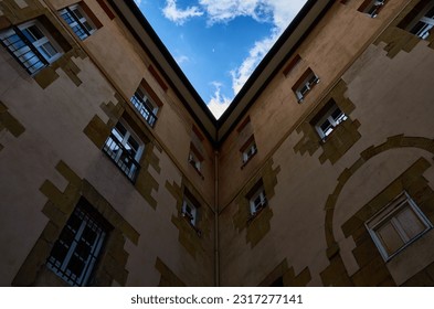Inner corner of a building creating a triangular shape of the sky.