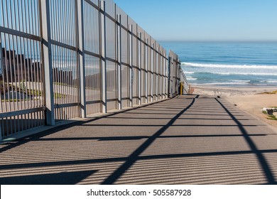 Inner fence of the international border wall which extends out into the Pacific ocean and separating San Diego, California from Tijuana, Mexico.