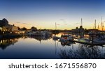 Inner Harbour of Victoria in sunset light. skyline with the bright evening lights of Victoria City, lights reflected on the water of the bay, British Columbia, Canada, Vancouver island