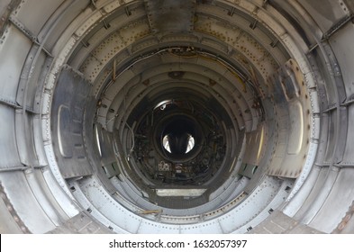 The inner metal lining of empty military fighter. Abandoned aircraft inside view