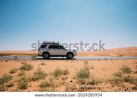 Inner Mongolia ,China - Circa 2021:  Driving White 2020 Toyota 4Runner TRD crossing in the desert road trip 
