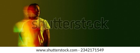 Inner self. Creative portrait of handsome young guy with neon filter reflection on gradient green background. Mixed light effect. Concept of art, fashion, modern style, cyberpunk, futurism, ad. Banner