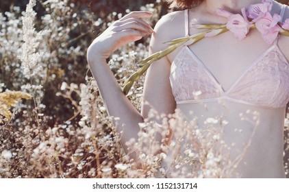 Innocent Girl In Pink Bra. Flowers Petals On Thin Delicate Skin. First Time, First Love. Sensual, Tender, Innocence.Goose Pimples, Bumps.