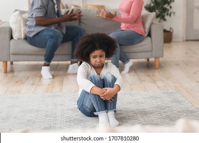 Innocent Little Black Girl Suffering From Family Conflicts, Sitting Alone On Floor And Feeling Upset, Cropped Image With Free Space