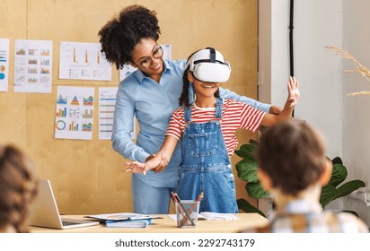 Innovation in education. Student schoolgirl  in virtual reality glasses together with teacher during lesson in bright classroom at school
 - Powered by Shutterstock