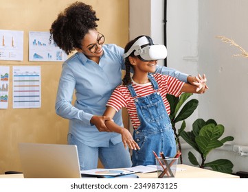 Innovation in education. Student schoolgirl  in virtual reality glasses together with teacher during lesson in bright classroom at school
 - Powered by Shutterstock