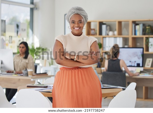 Innovation, leadership and a proud black\
business woman standing in power in a corporate office. Happy\
African American leader excited by successful goal management with\
diverse female\
employees