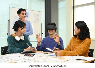 Innovation, technology and futuristic concept. Developers team brainstorming, testing virtual reality simulator glasses at meeting - Powered by Shutterstock