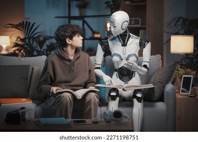 Innovative AI robot tutor helping a teenage boy with homework, they are reading books together, human-robot interaction concept - Shutterstock ID 2271198751
