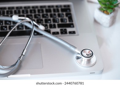 Innovative approach to medical care: stethoscope placed on a laptop, signifying online consultation. Digital healthcare solutions concept - Powered by Shutterstock