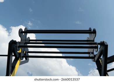 Innovative design elements are highlighted as sunlight reflects off the black and yellow roller coaster structure against a bright sky, creating an exhilarating atmosphere.