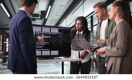 Innovative Developer Guides Team Through Coding Presentation On Big Screen.