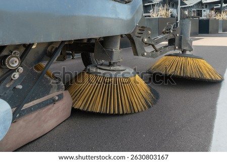 Innovative electric street sweeper efficiently cleaning pedestrian walkways and bike paths for a cleaner, greener urban environment.