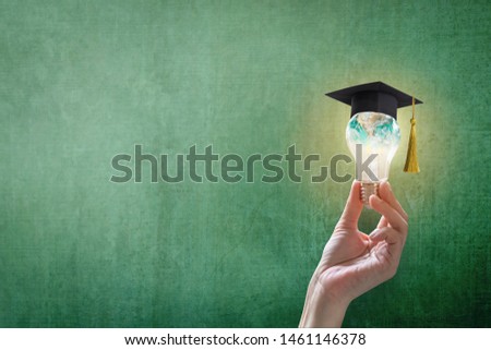 Innovative learning, creative educational study concept for graduation and school student success with world lightbulb on teacher chalkboard