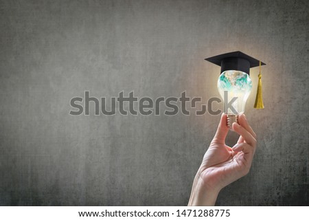 Innovative learning, creative educational study concept for graduation and school student success with world lightbulb on teacher chalkboard
