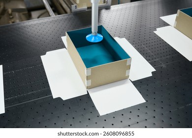 Innovative robotic gluing process at a box manufacturing plant showcasing precision and efficiency in production