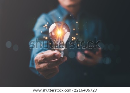 innovative technology in science and communication concepts,Technology creativity for future inventions and developments,Business for innovative solution concept,Businessman holding a light bulb