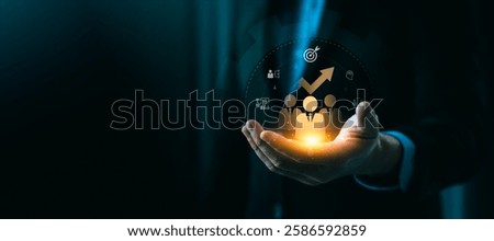 Innovative Training and Development Concept Depicting a Businessman's Hand Holding Digital Icons Representing Workforce Growth, Skills Improvement, and Strategic Success