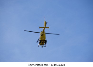 Innsbruck/Tyrol/Austria - 03/16/2019: An austrian yellow air ambulance helicopter flying a rescue trip.