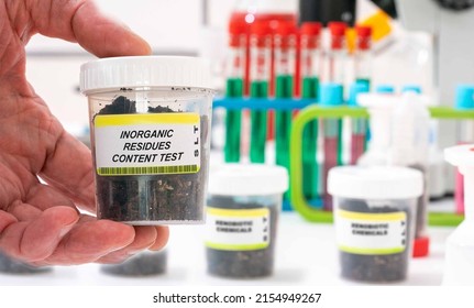 Inorganic Residues. Inorganic Residues content in soil sample in plastic container. Study of agricultural soil in a chemical laboratory