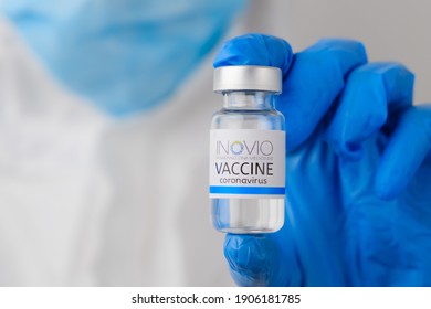 INOVIO coronavirus vaccine in doctors or nurses hands in blue rubber gloves. Prevention of sars-cov-2 or Covid-19, January 2021, San Francisco, USA
