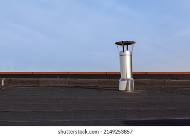 Inox Chimney On The Flat Roof In The City