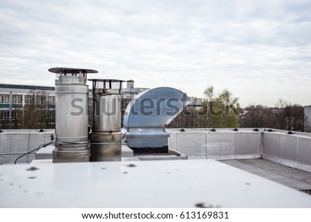 inox Chimney on the flat roof in the city