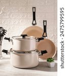 Inox or stainless steel cooking utensil set including slotted pans, pots, spoon, slotted turner, pasta server, slotted spatula, deep soup ladle, solid spoon, kitchen tongs, egg whisk, basting brush