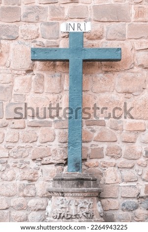 Inri christian cross symbol behind of catedral wall in Cusco Peru. Selective focus. 