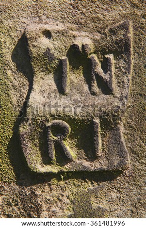 INRI letters at an old tombstone