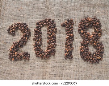 The inscription 2018 made by coffee beans on burlap background. - Powered by Shutterstock